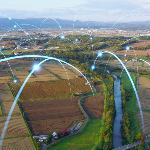 Aerial view of rural landscape with digital lines illustrating Bigleaf's wireless network coverage by Allstate Peterbilt, emphasizing enhanced connectivity and reliability in underserved areas.