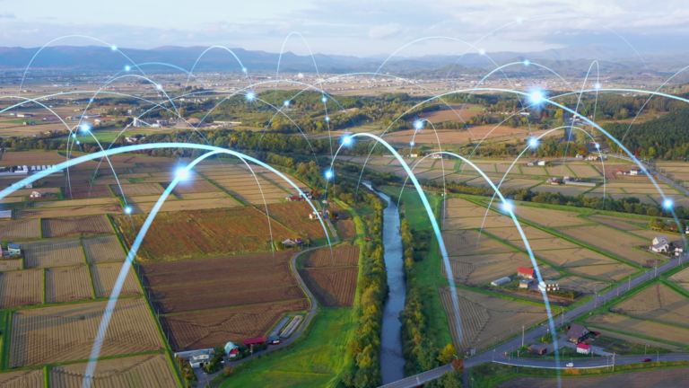 Aerial view of a rural landscape with digital network lines representing 4G LTE and 5G technology, symbolizing advanced mobile connectivity and internet coverage in remote areas with Bigleaf Networks.