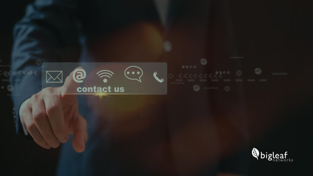 A hand reaching toward digital icons, including email, wireless, chat, and phone symbols, with a contact us label in a sleek and professional design, accompanied by the Bigleaf Networks logo.